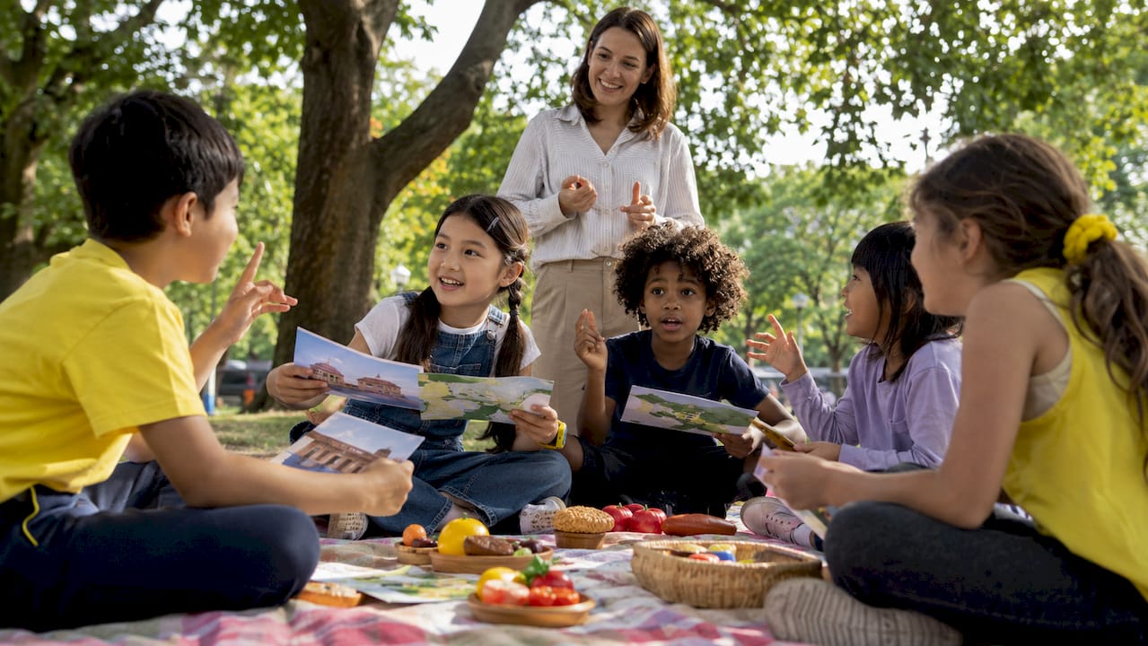 Children practicing French role-play in classroom