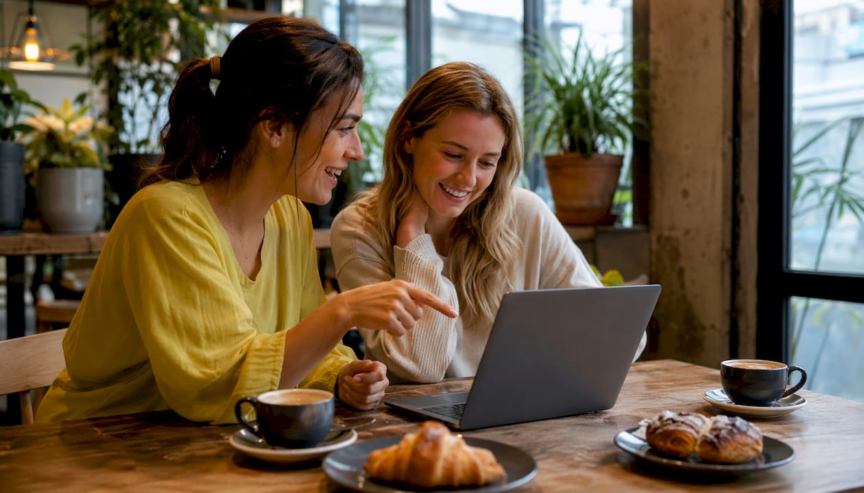 Two people comparing music language apps at table