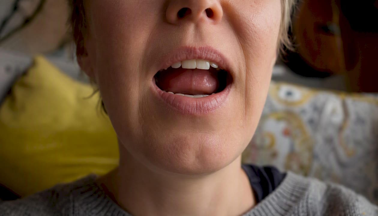 Close-up of mouth articulating German sounds