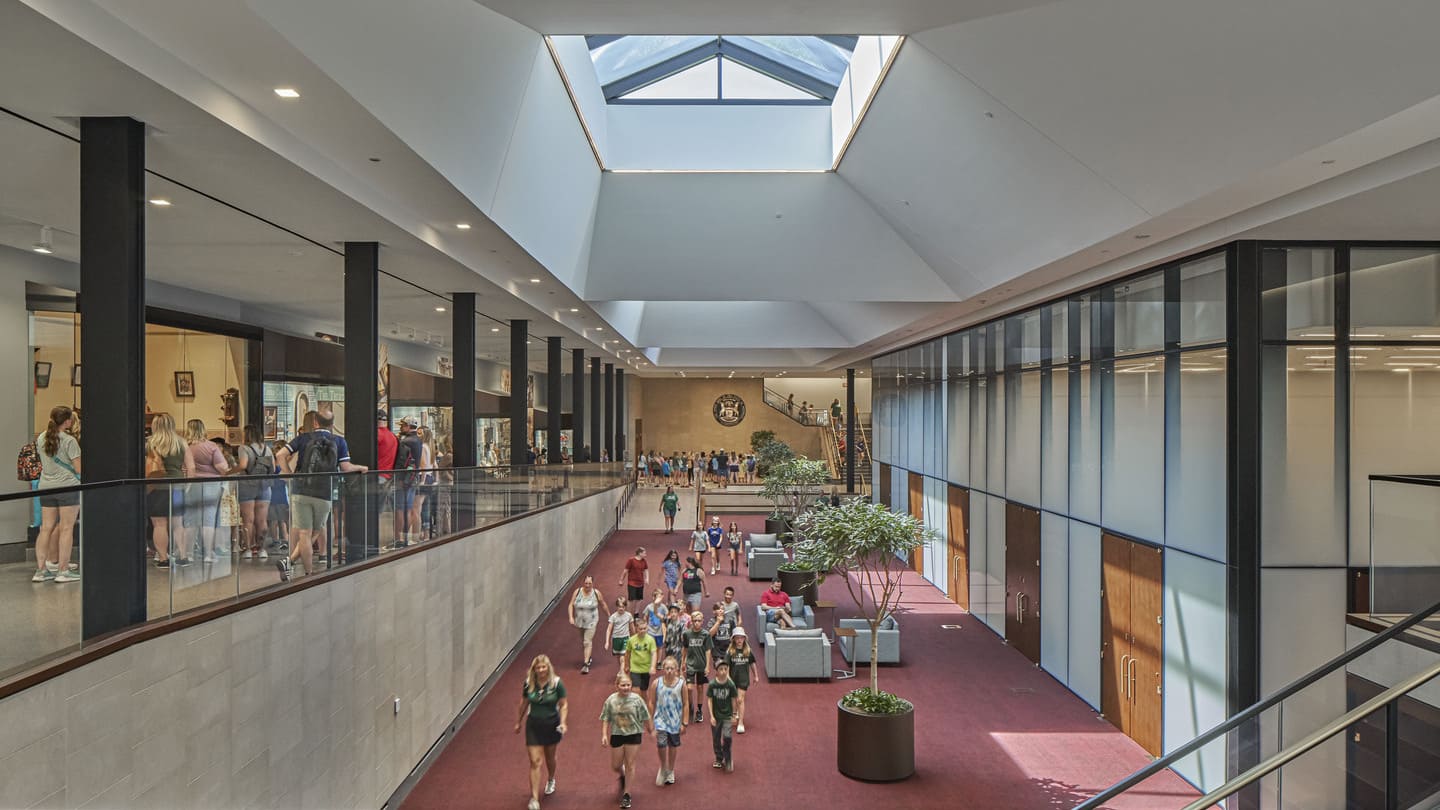 An interior photo of a two-level gathering space connected by a ramp.