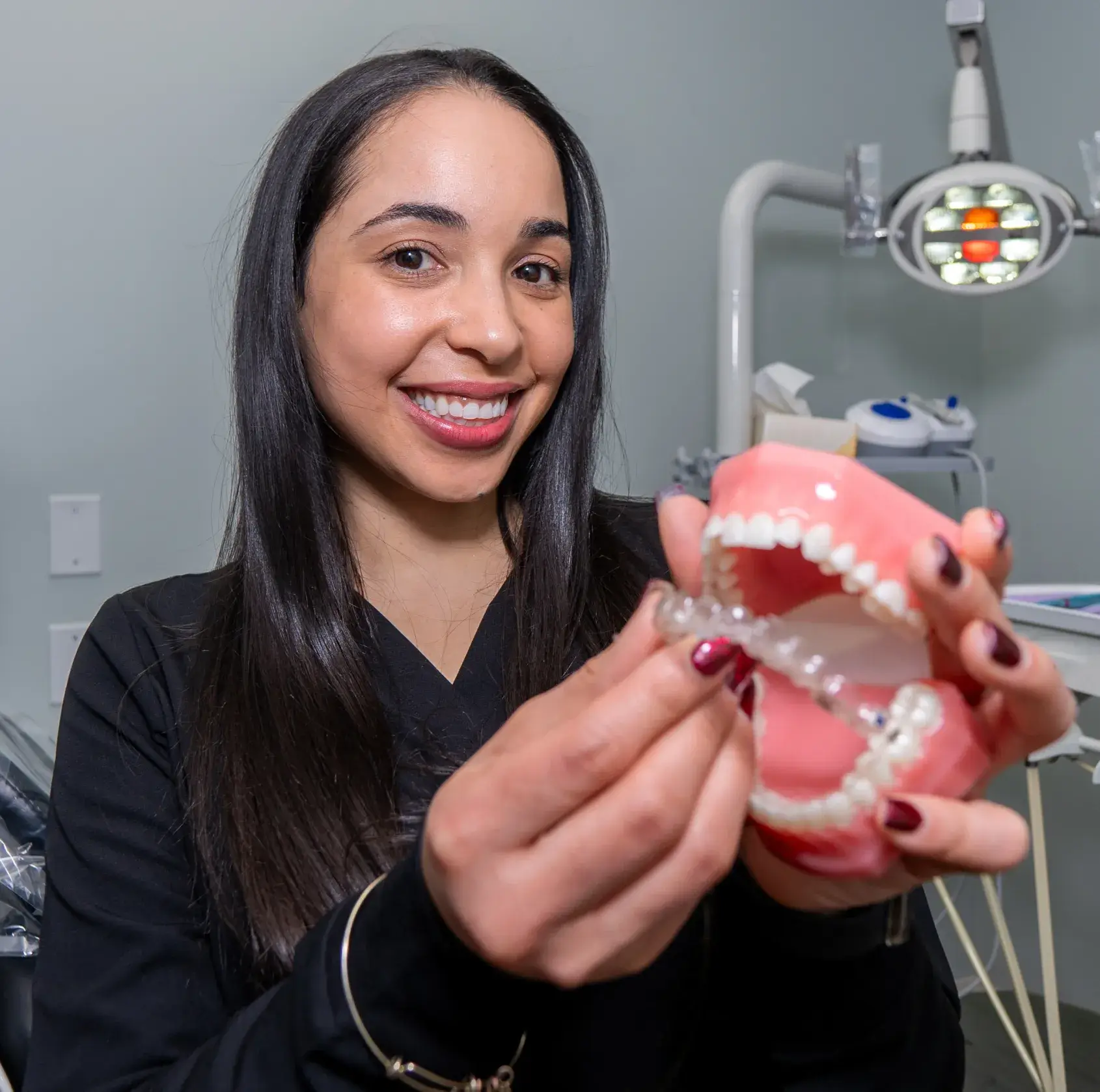 Team member putting a clear aligner to a denture
