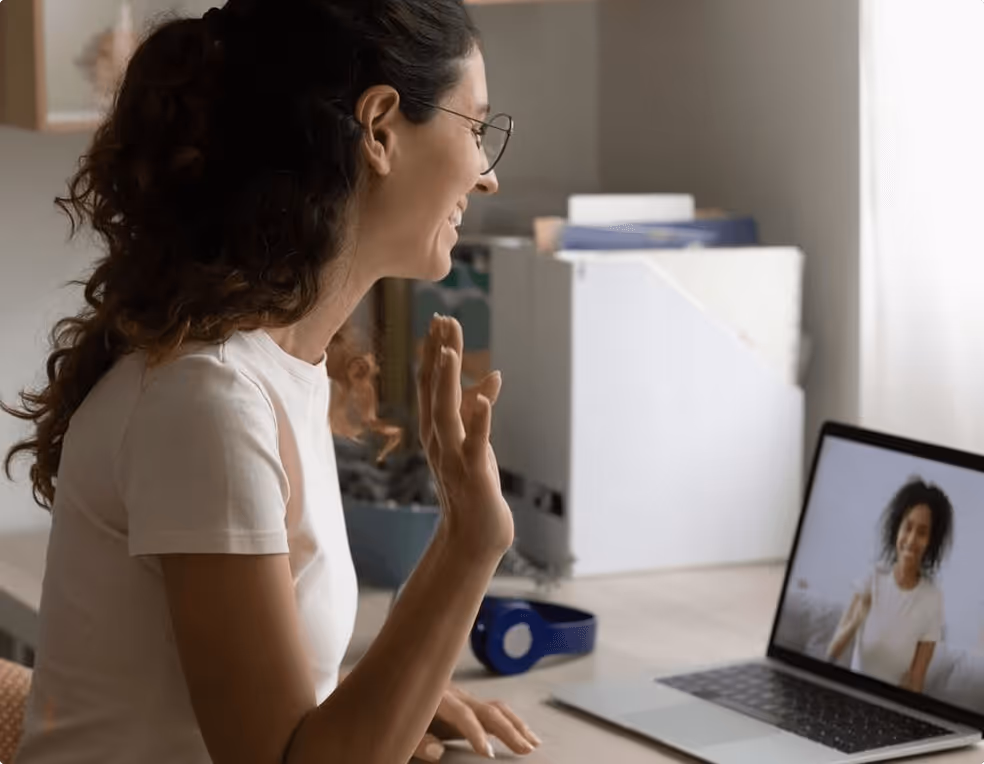 A woman sitting in front of a laptop computer.