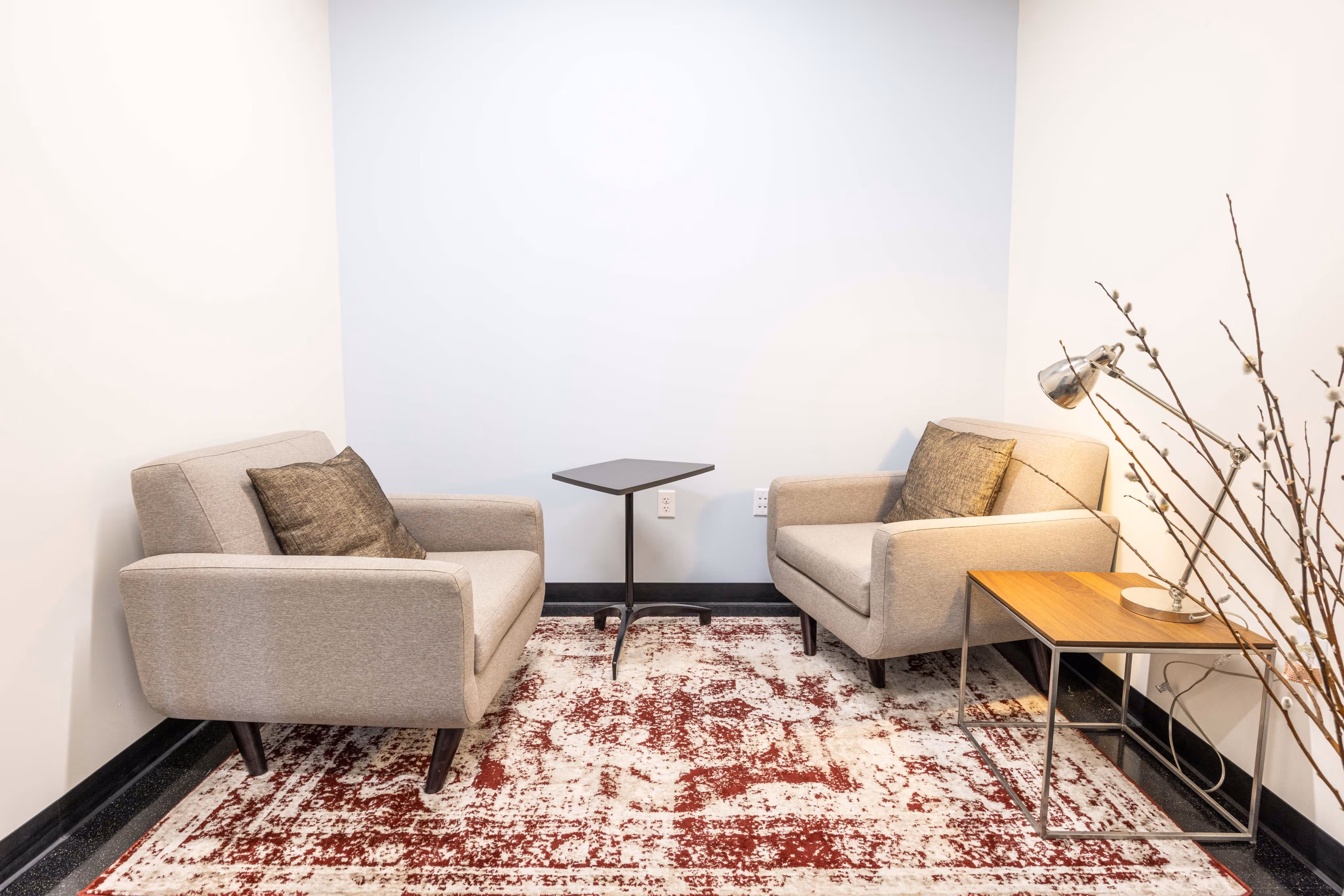 Two chairs and a table in a room.