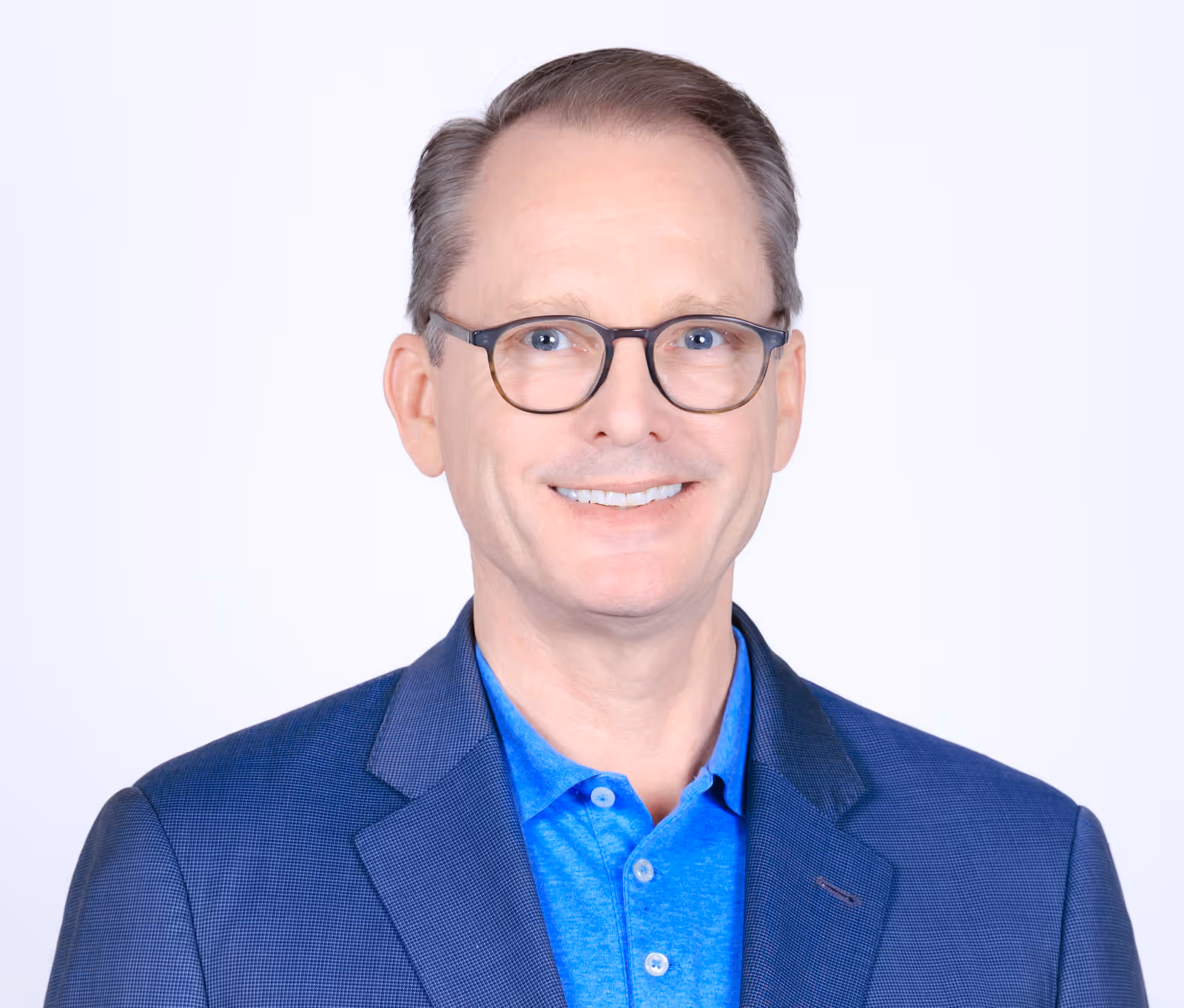 A man wearing glasses and a blue shirt.