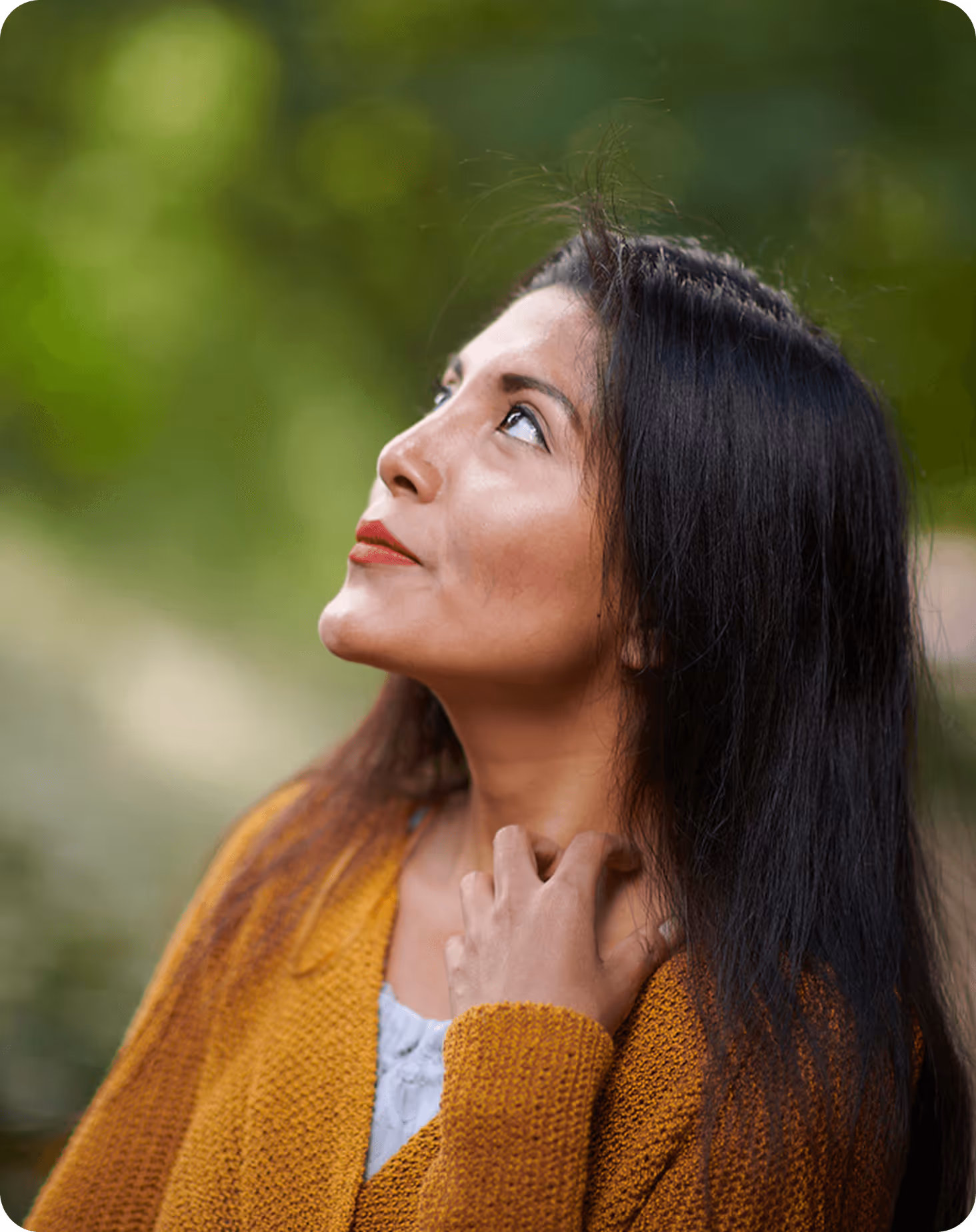 A woman with long black hair looking up.