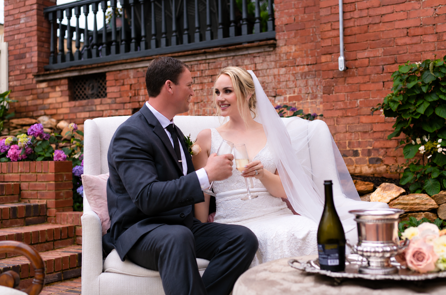 Bride and groom celebrating outdoors during the wedding styled shoot
