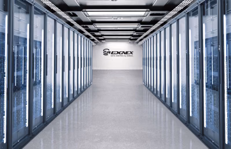 Long corridor with rows of server racks on both sides in a modern data center room.