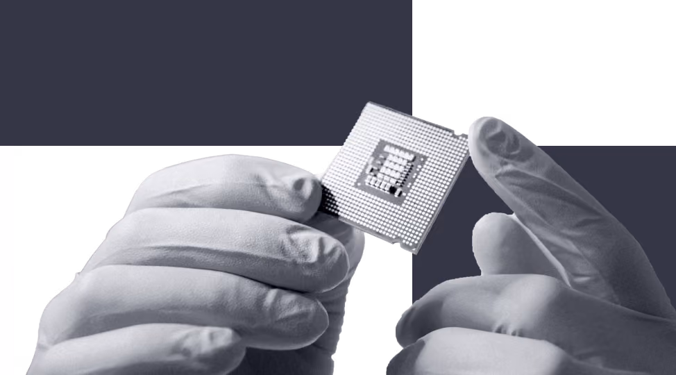 Hands wearing gloves holding a small computer processor chip.