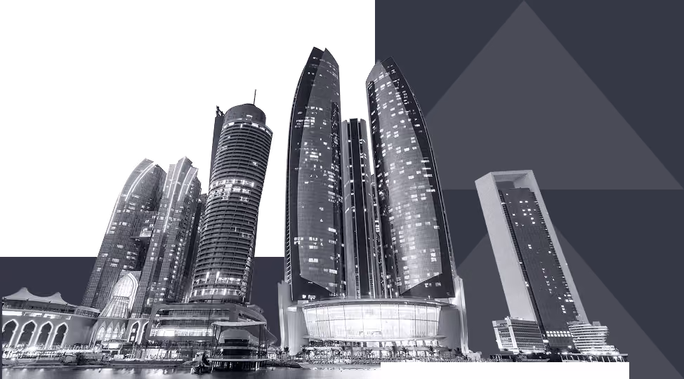Night view of illuminated modern skyscrapers with reflections on water.