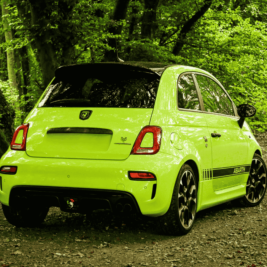 Pickup truck pulling a livestock trailer across a grassy rural field