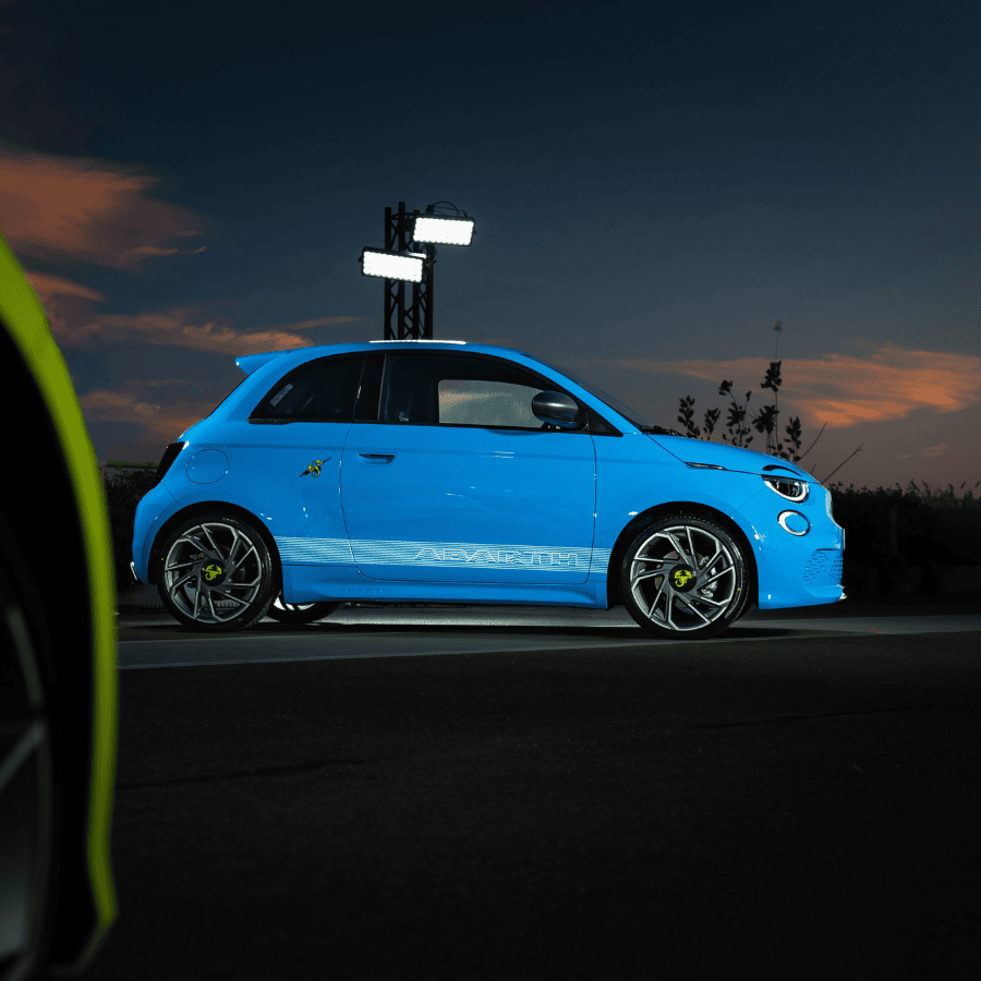 White pickup truck on dusty dirt road through arid rocky landscape