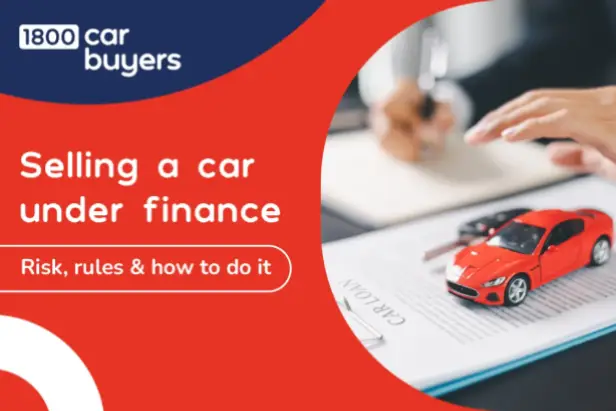 Red toy car placed on a finance document with a person signing paperwork in the background, illustrating the process of selling a car under finance for 1800 Car Buyers.