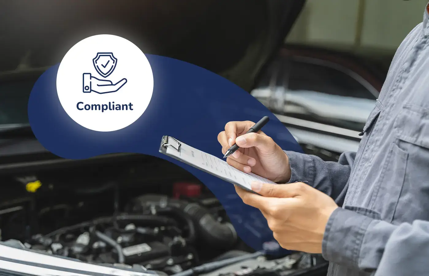 Mechanic writing on a clipboard in front of an open car engine with a graphic label indicating the vehicle is compliant.