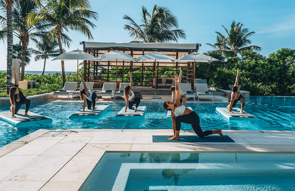 a group of people doing yoga in a pool