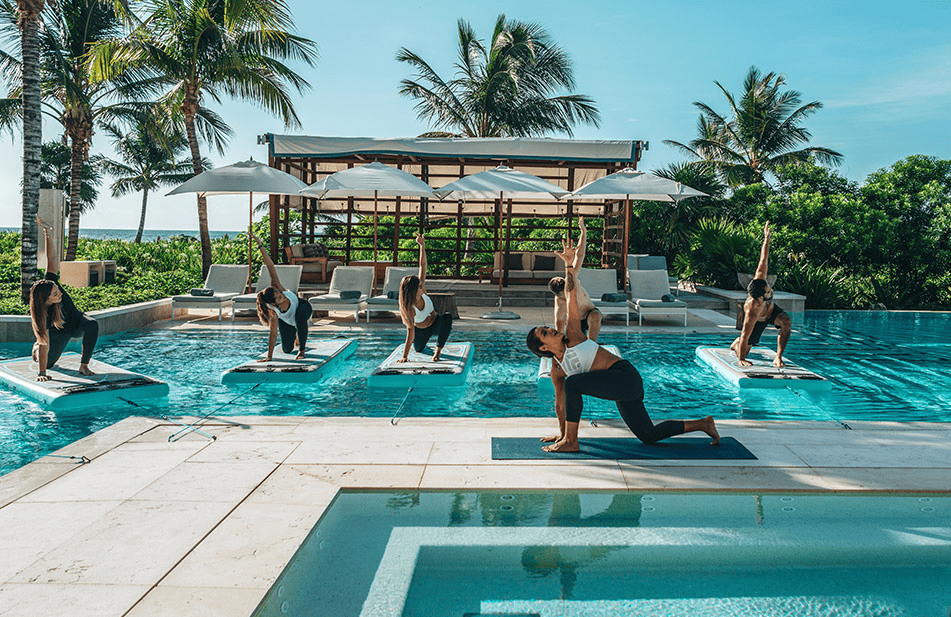 a group of people doing yoga in a pool