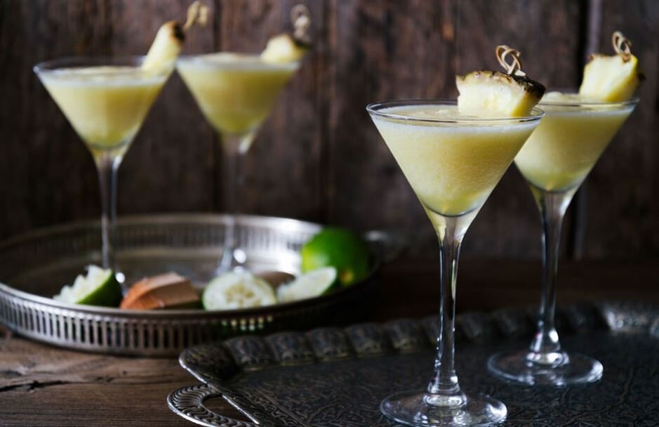 a group of glasses with a drink in it