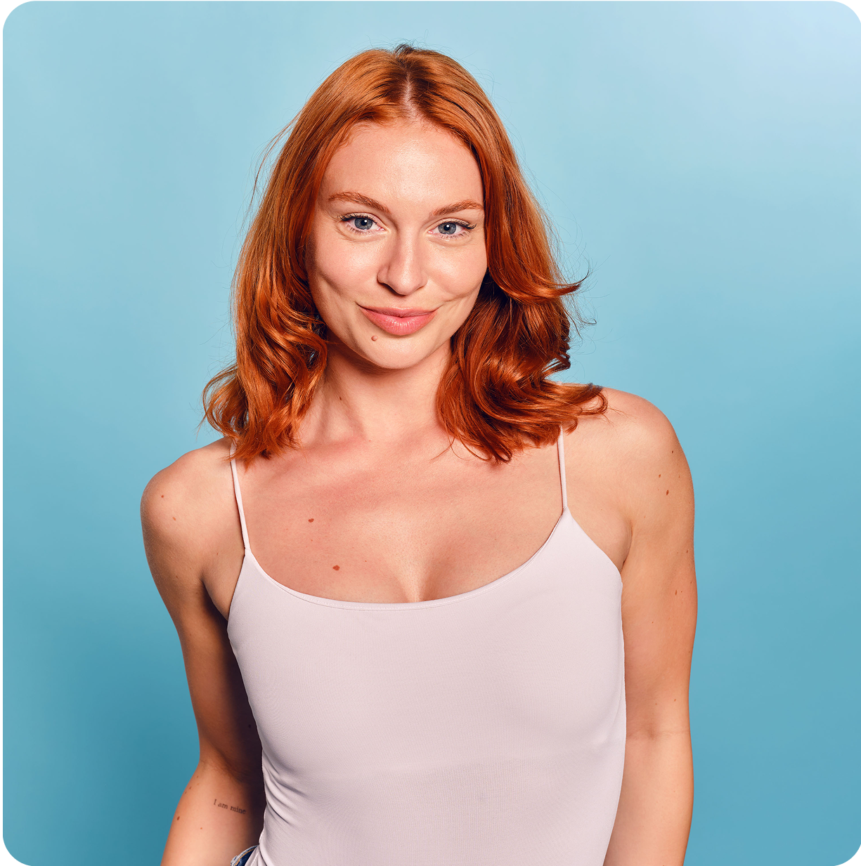 Woman on a blue background in a Lazy Tan campaign shot