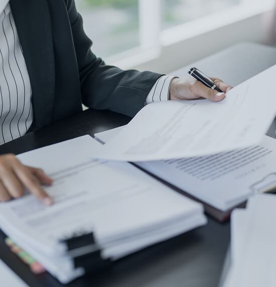 Close up of documents on a desk being reviewed by a lawyer.