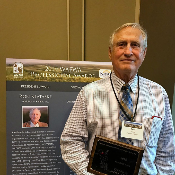 Ron Klataske holding the plaque awarded him by WAFWA