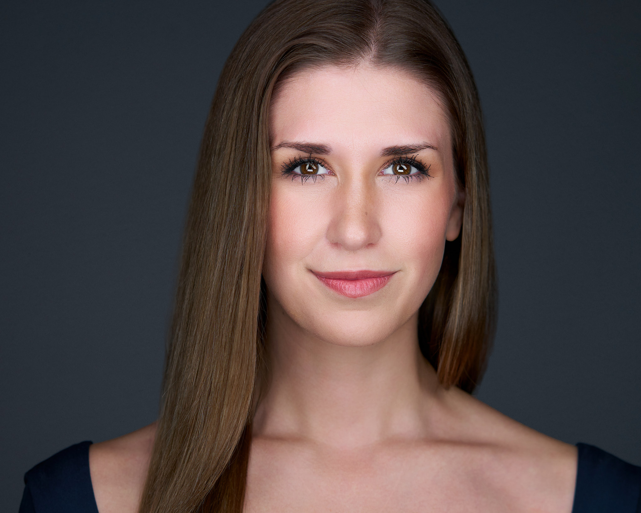 On-Location Corporate Headshots at On Site Headshots made for a corporate group headshot session — white female with long blonde hair and a bright smile, wearing a light top