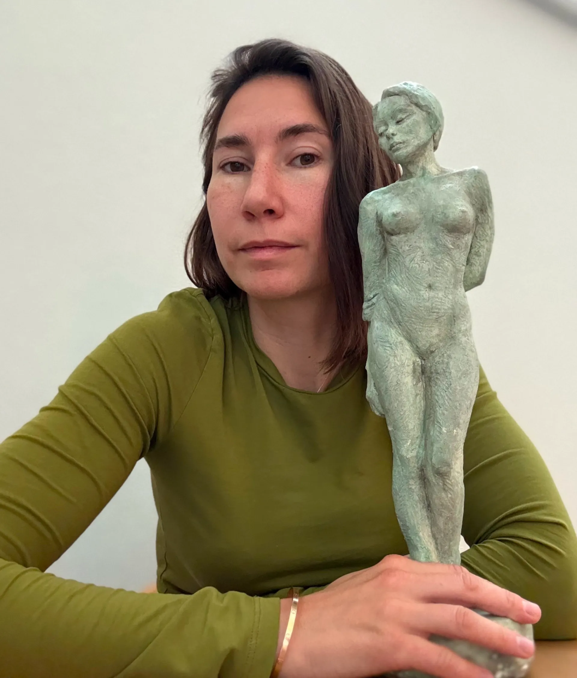 Marina Kokush Product Manager and UX Designer with art object.