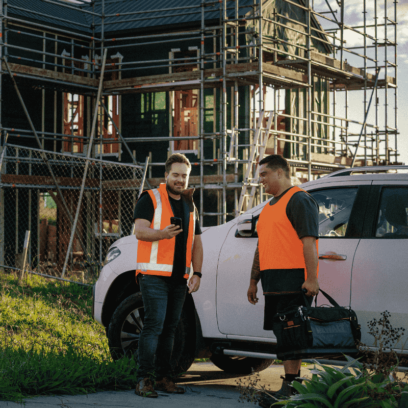 A photo of a man using Paysauce on his phone on a construction site