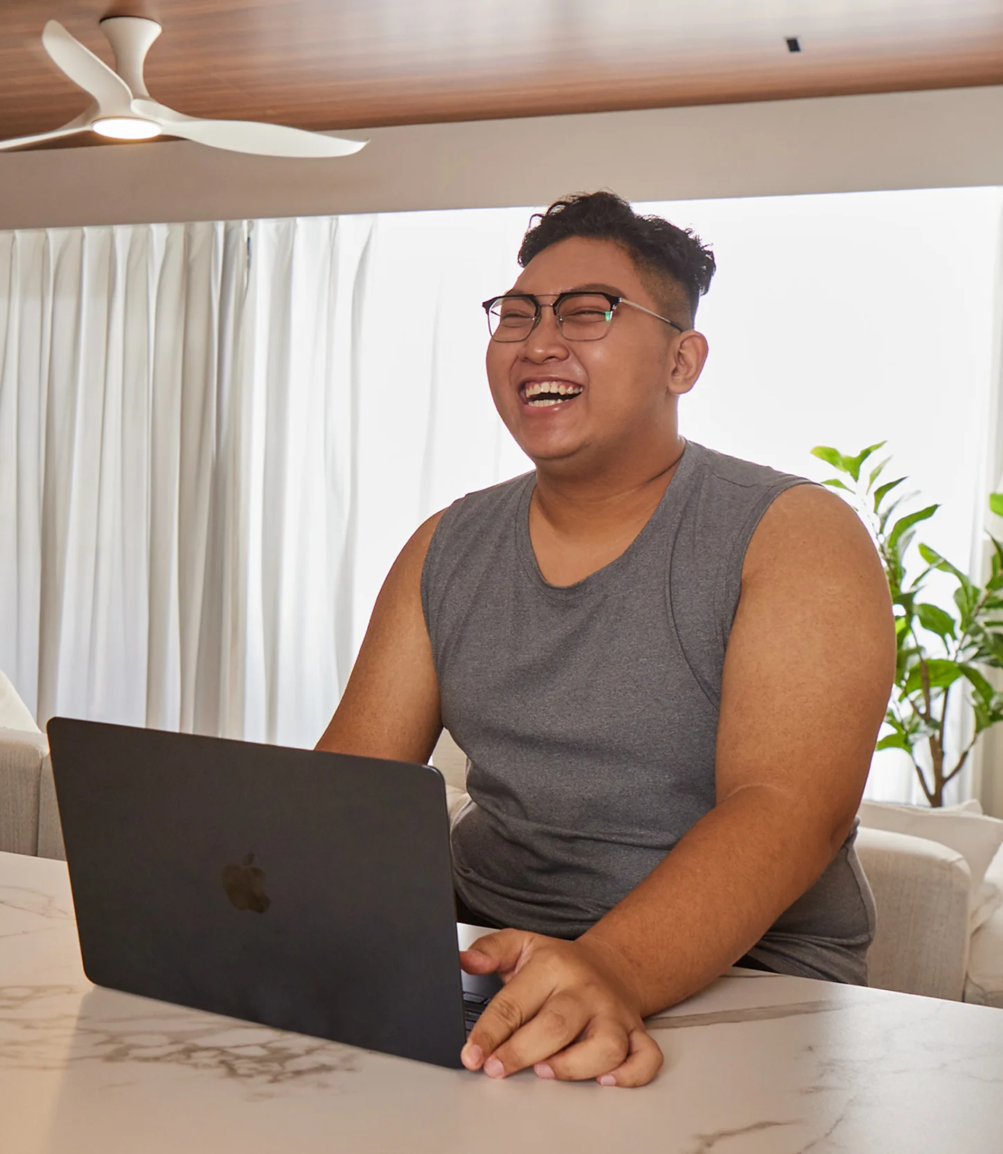 A short-haired Singaporean man in a white hoodie standing in broad daylight
