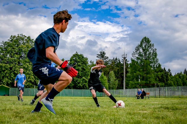 Youth soccer players competing on a grassy field, emphasizing integrity and sportsmanship.