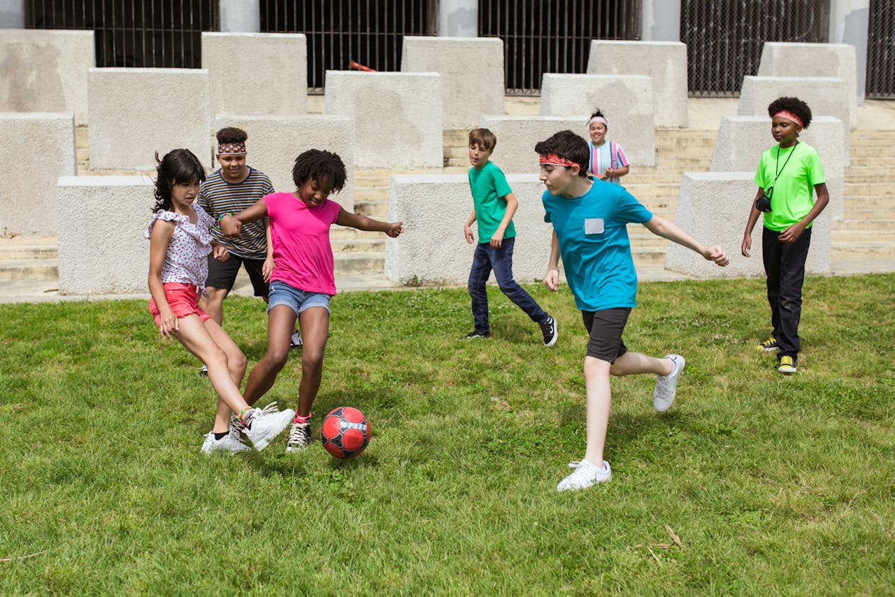 Children from diverse backgrounds playing soccer, emphasizing inclusivity and equal opportunities in the sport.