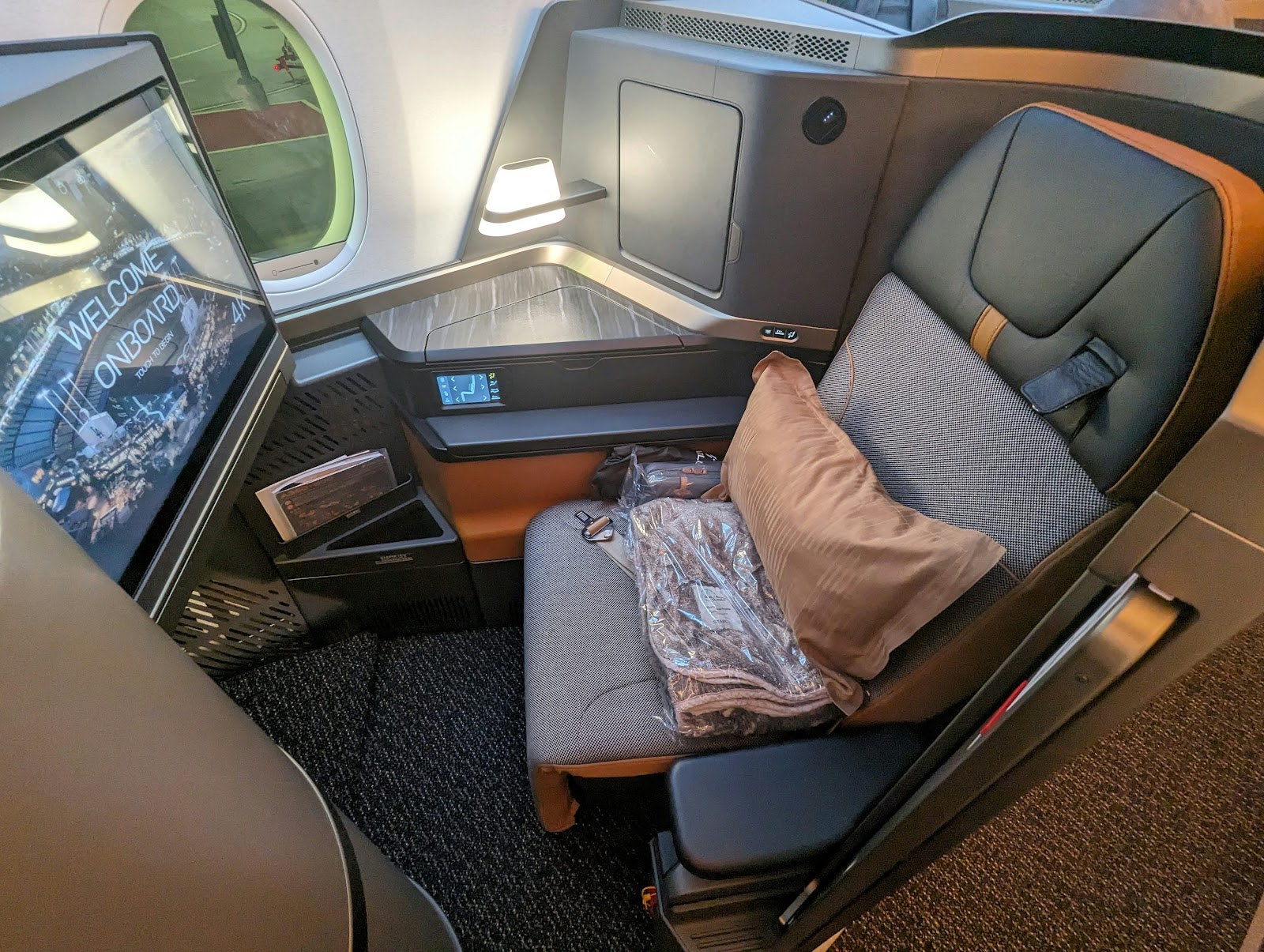 a seat on an airplane with a monitor