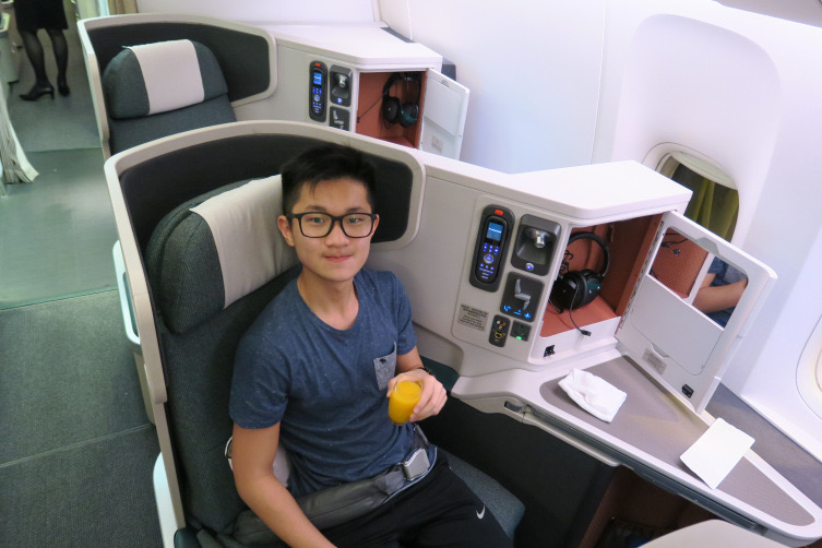 a man sitting in a chair with a drink in his hand