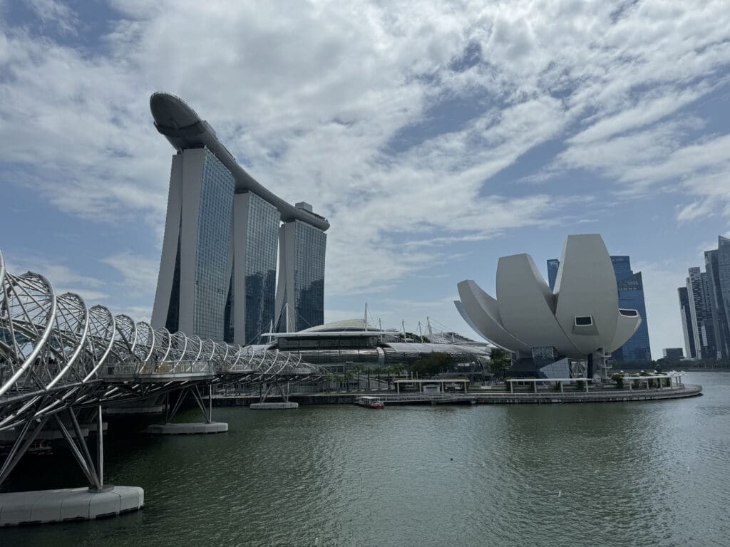 a bridge over water with buildings in the background