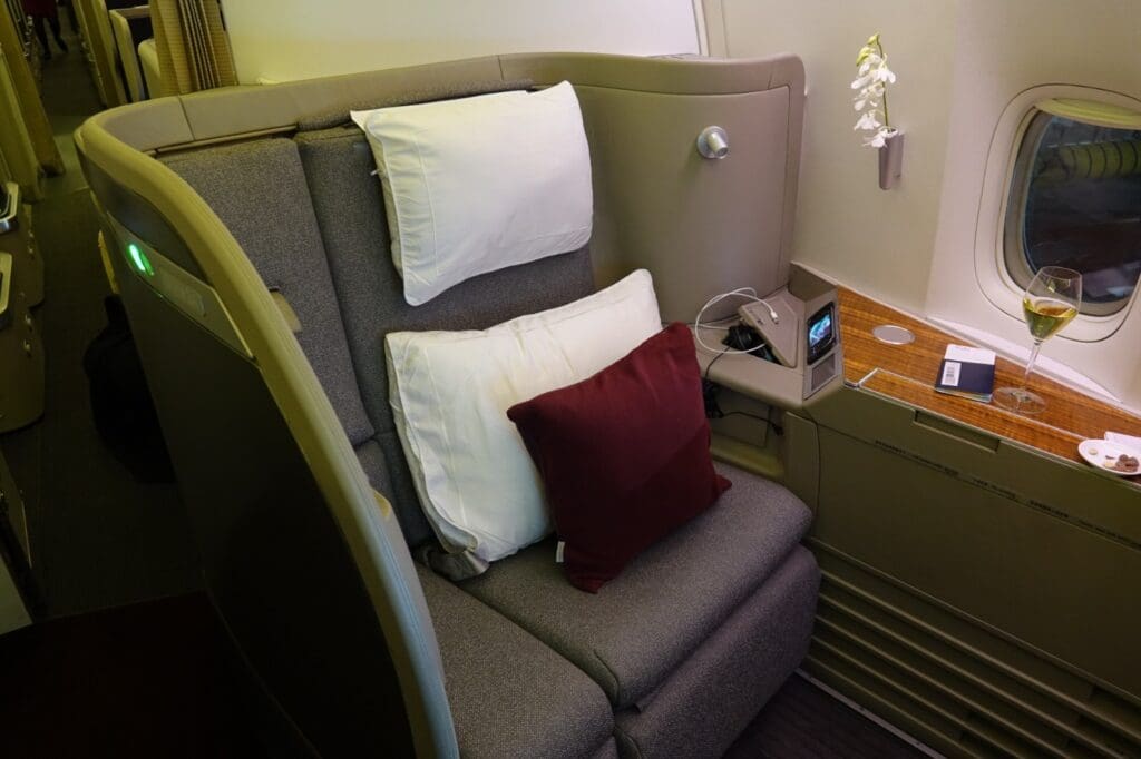 a couch with pillows and a phone on the side