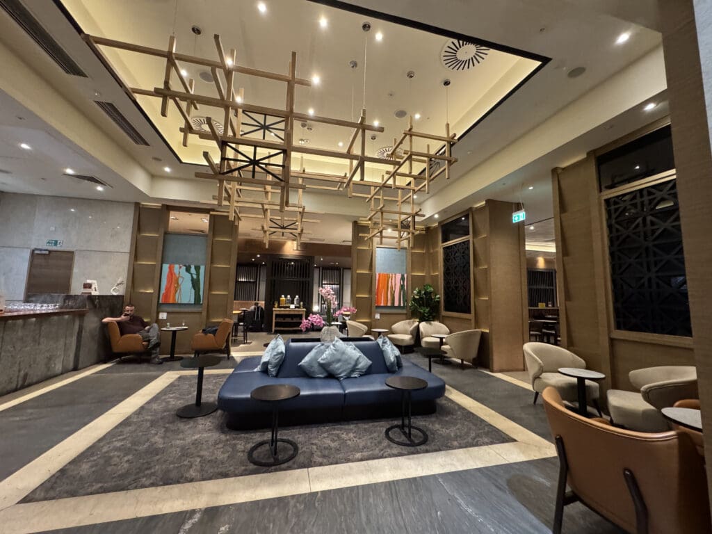 a room with a couch and chairs