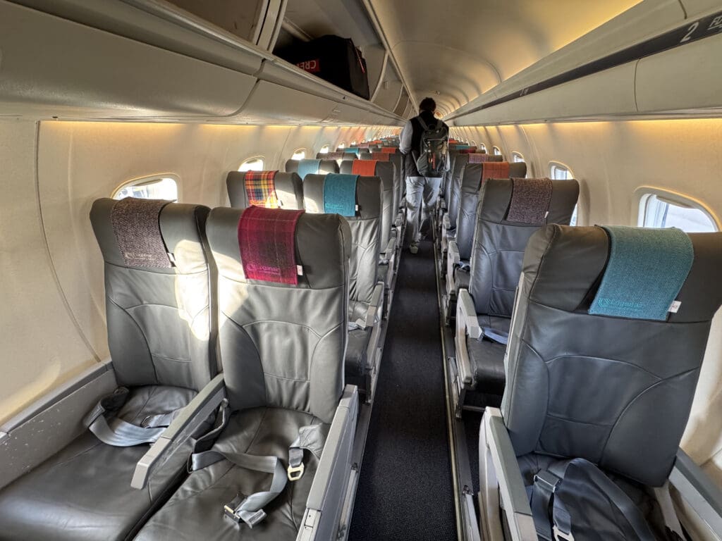 a person walking on the inside of an airplane