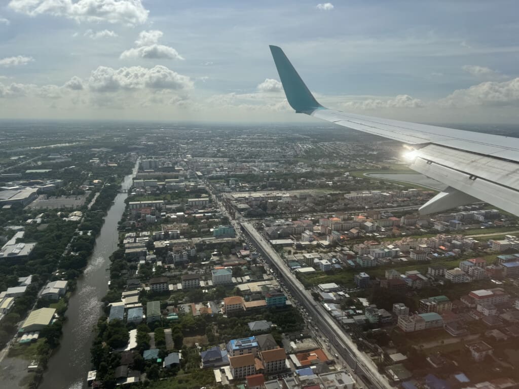 an airplane wing and city view from above