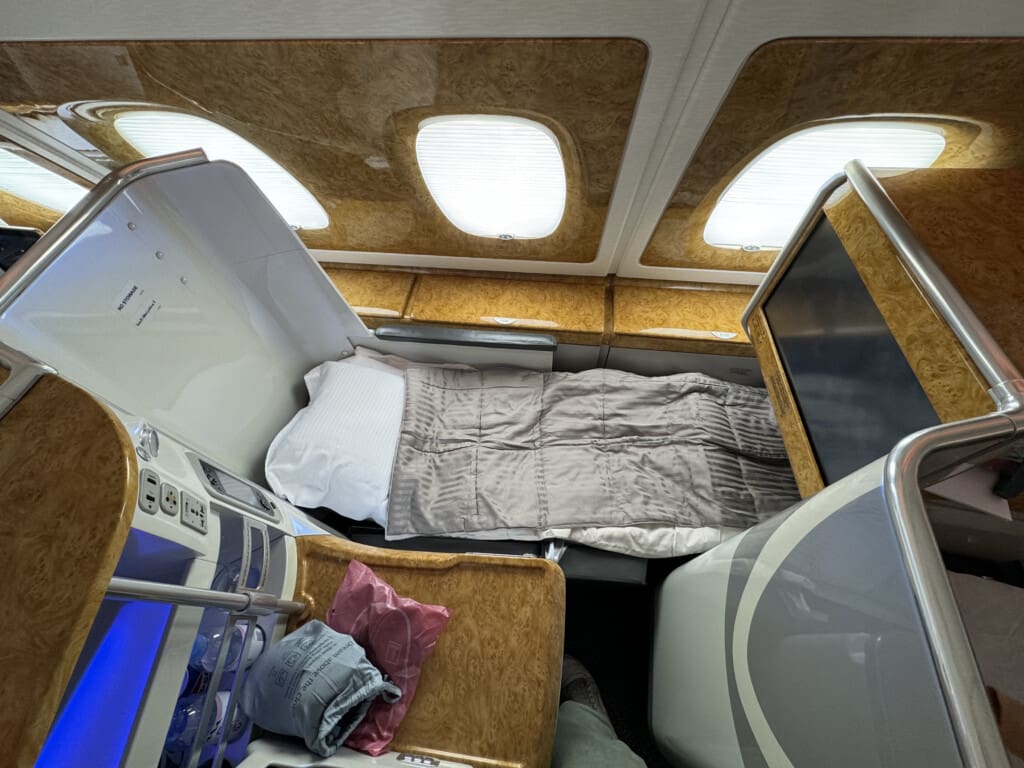 a bed and chair in an airplane