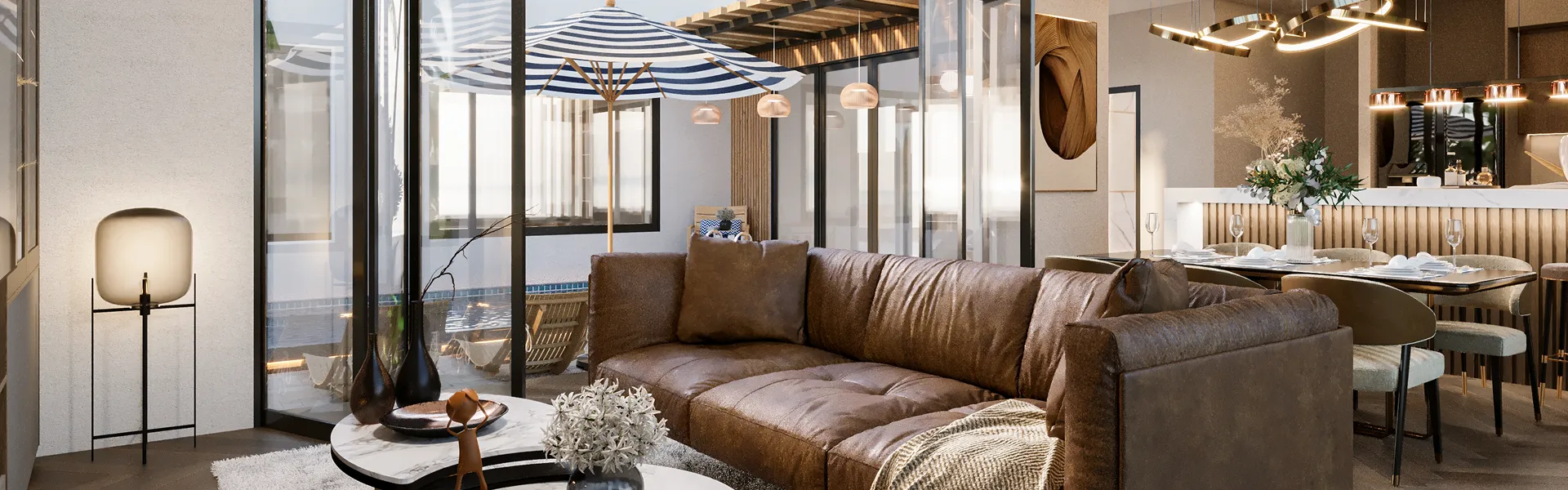 Modern living room with brown leather sofa, round marble coffee tables with vases, floor lamp, and dining table set behind.