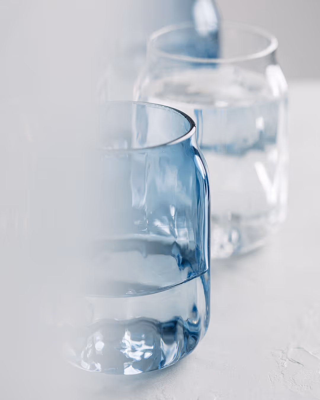 Tumblers in blue and clear glass stacked