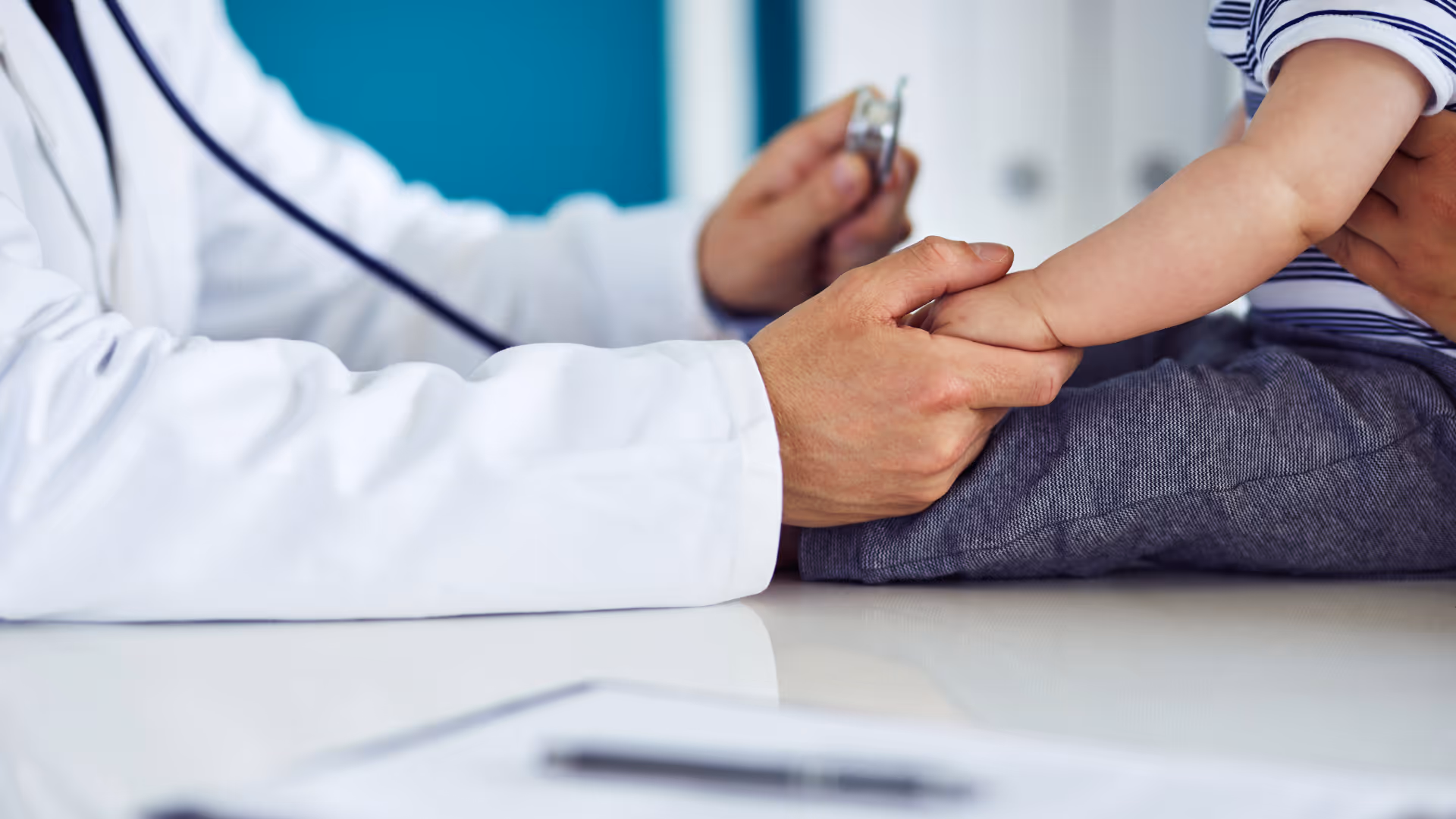 Pediatrician holding a child's hand
