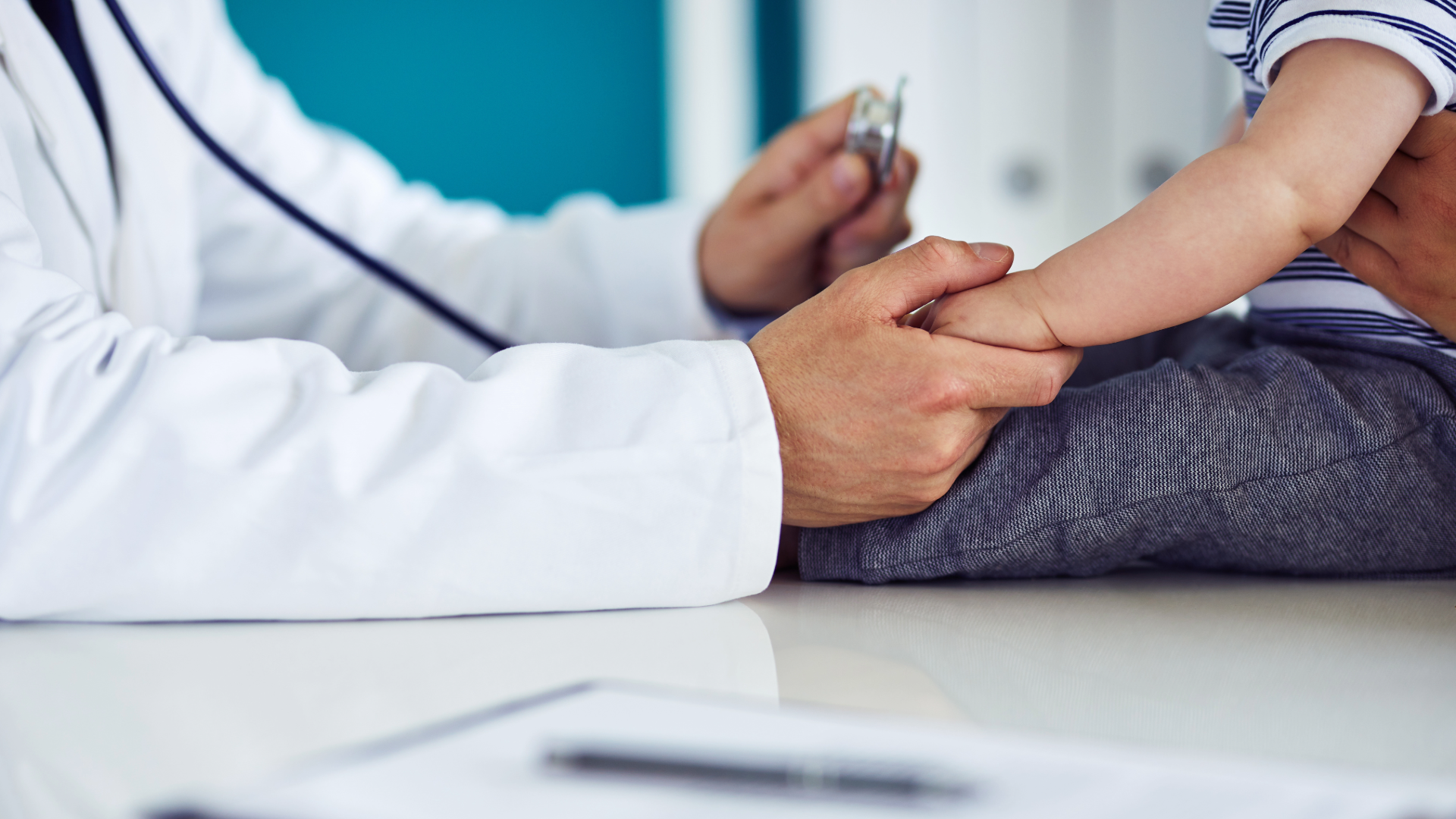 Pediatrician holding a child's hand