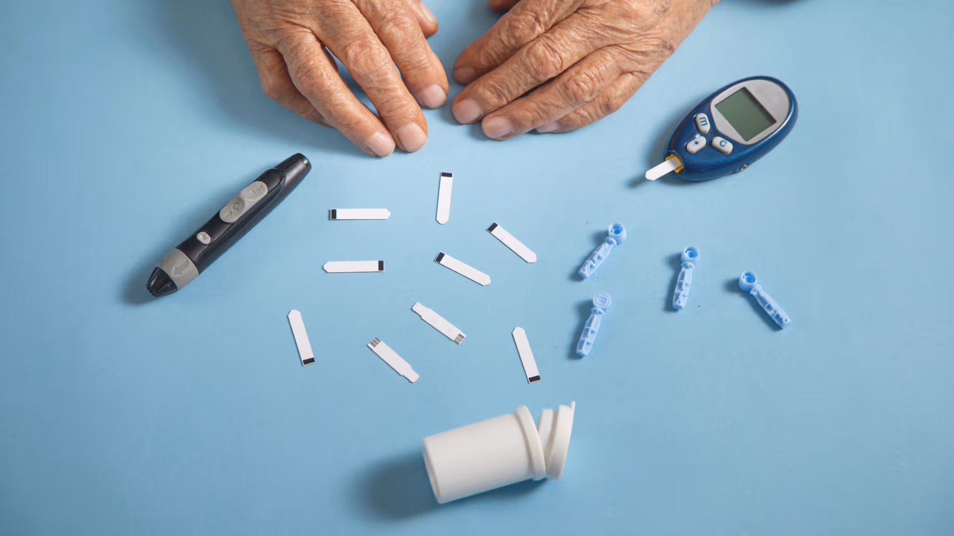Hands holding diabetes testing strips