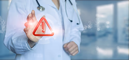 Physician pressing red alert button