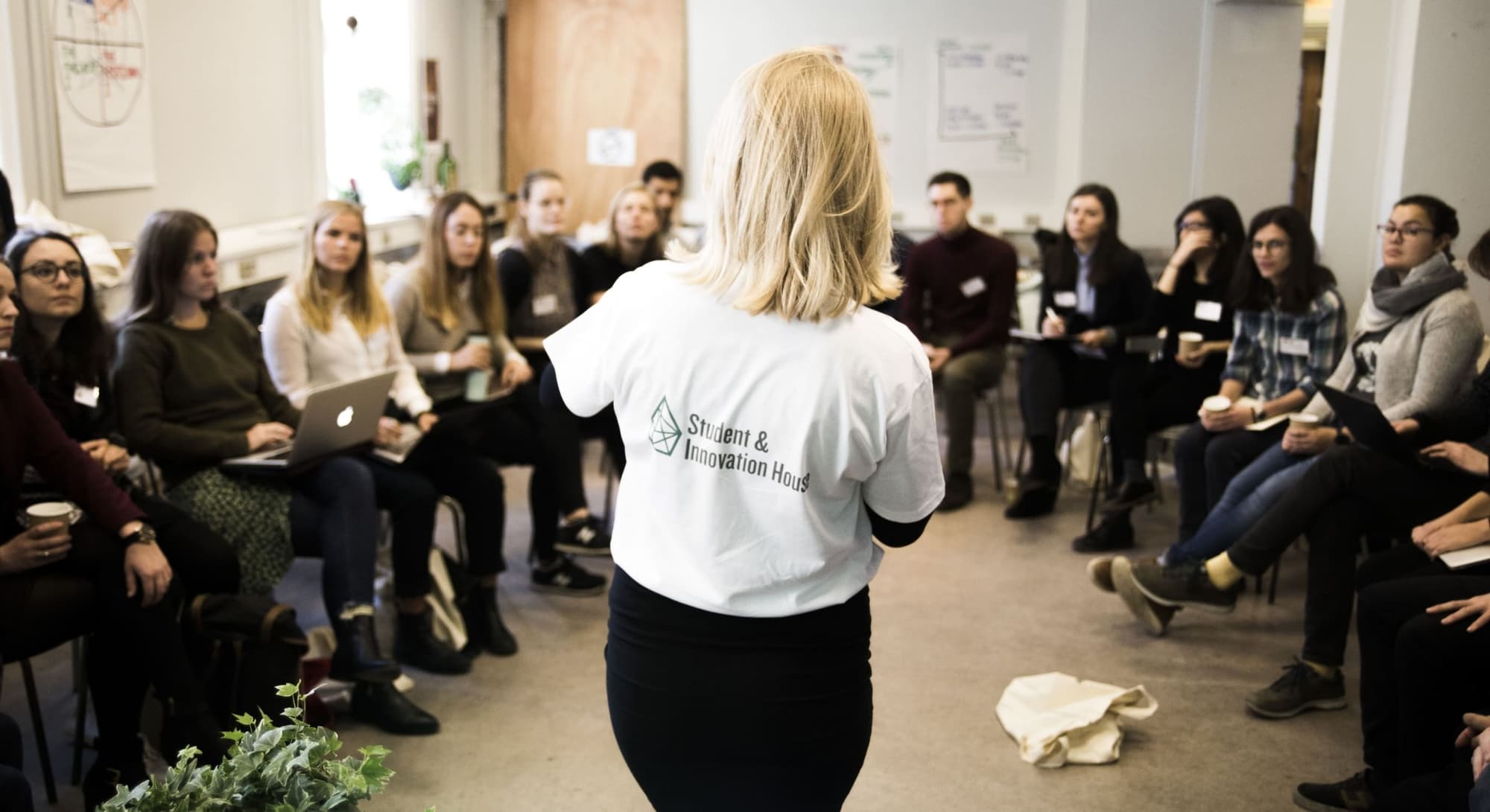 Woman doing a talt for a room of students