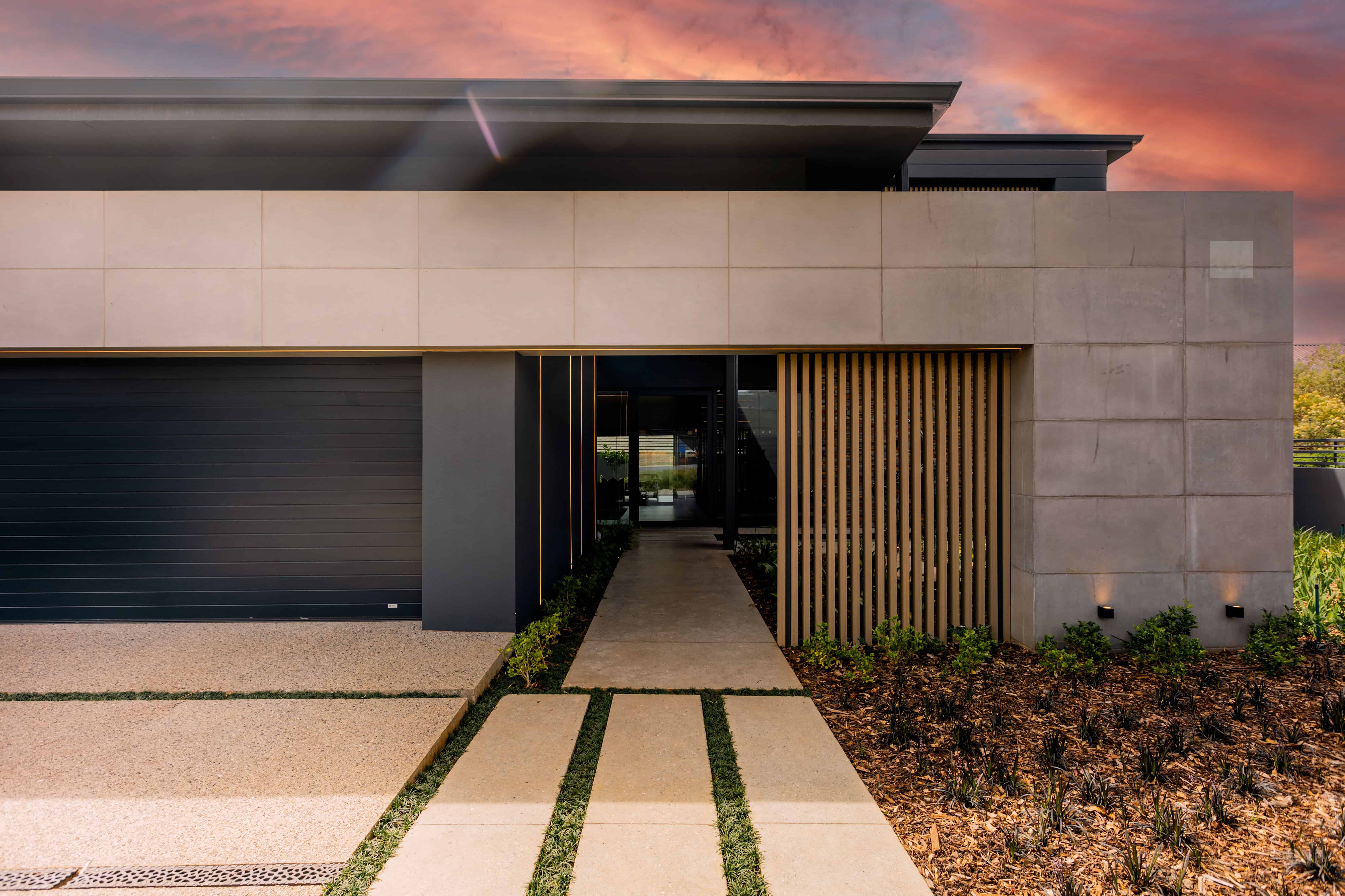 Contemporary residence front elevation with landscaped entryway by Johannesburg interior designer Renovatio.