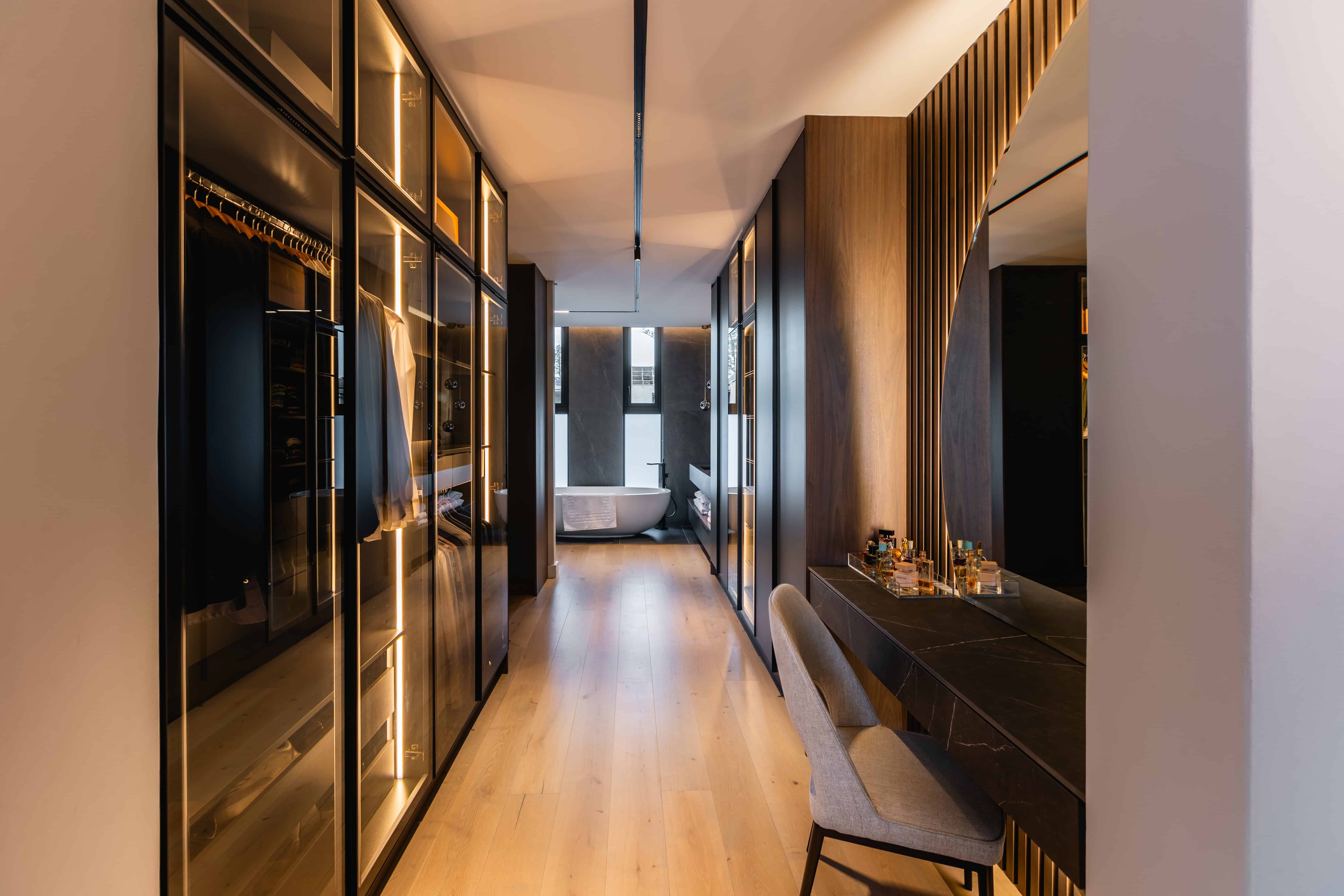 Walk-in dressing corridor with integrated wardrobe lighting in Steyn City luxury residence – Johannesburg interior designer Renovatio.