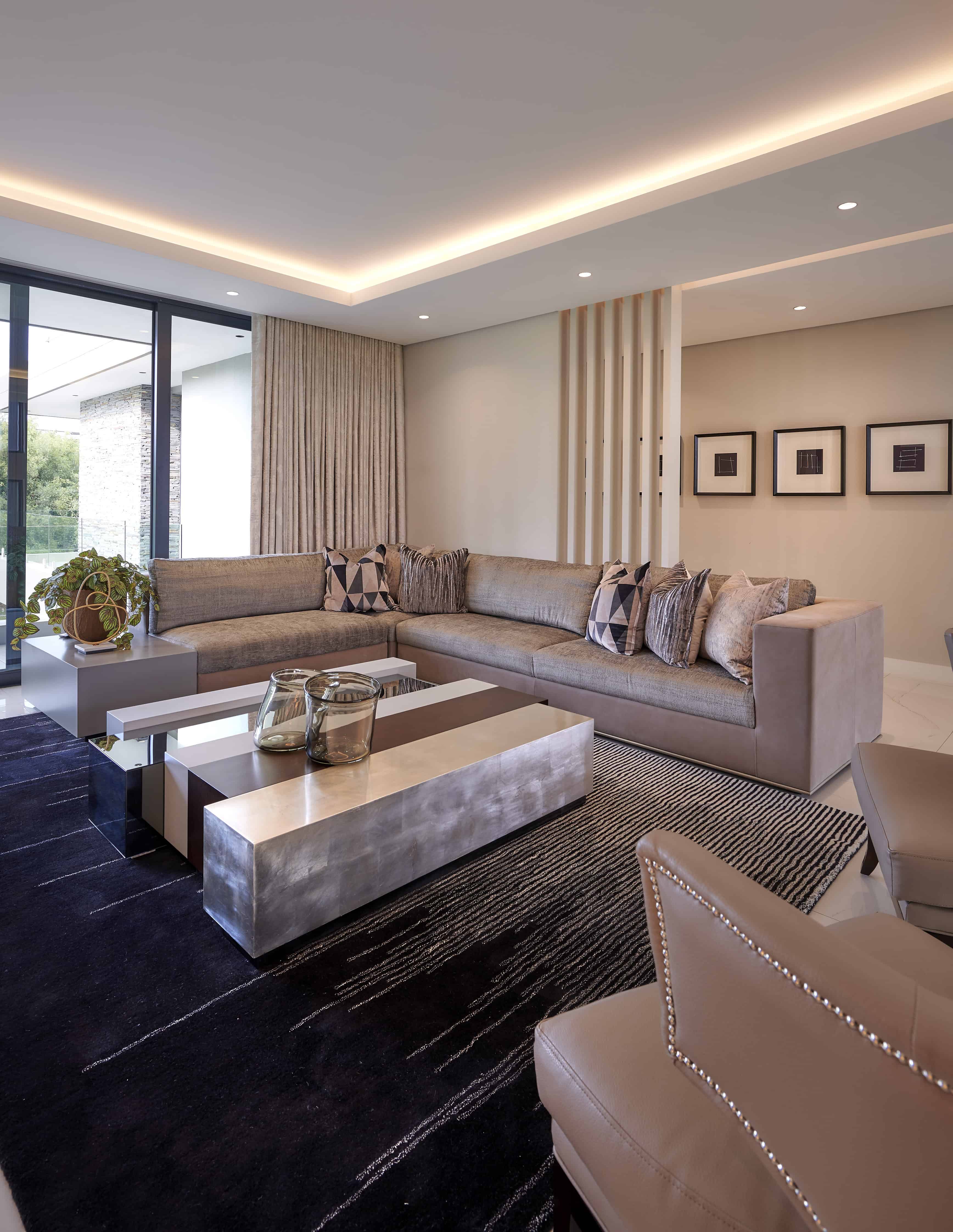 Luxurious dining room with statement lighting and contemporary chairs by Interior Designer Johannesburg.