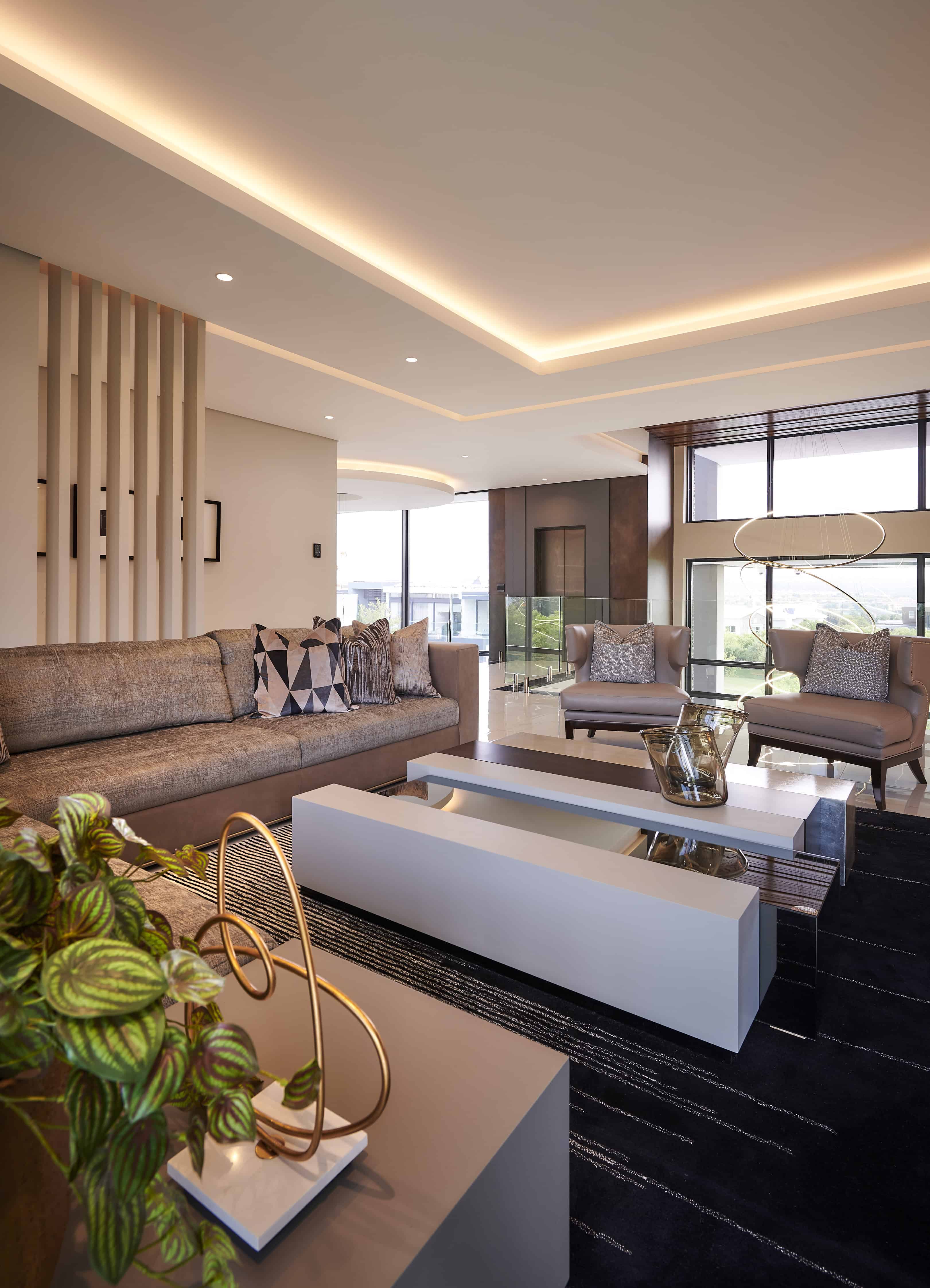Cozy seating area with fireplace and plush cushions created by Interior Designer Johannesburg.