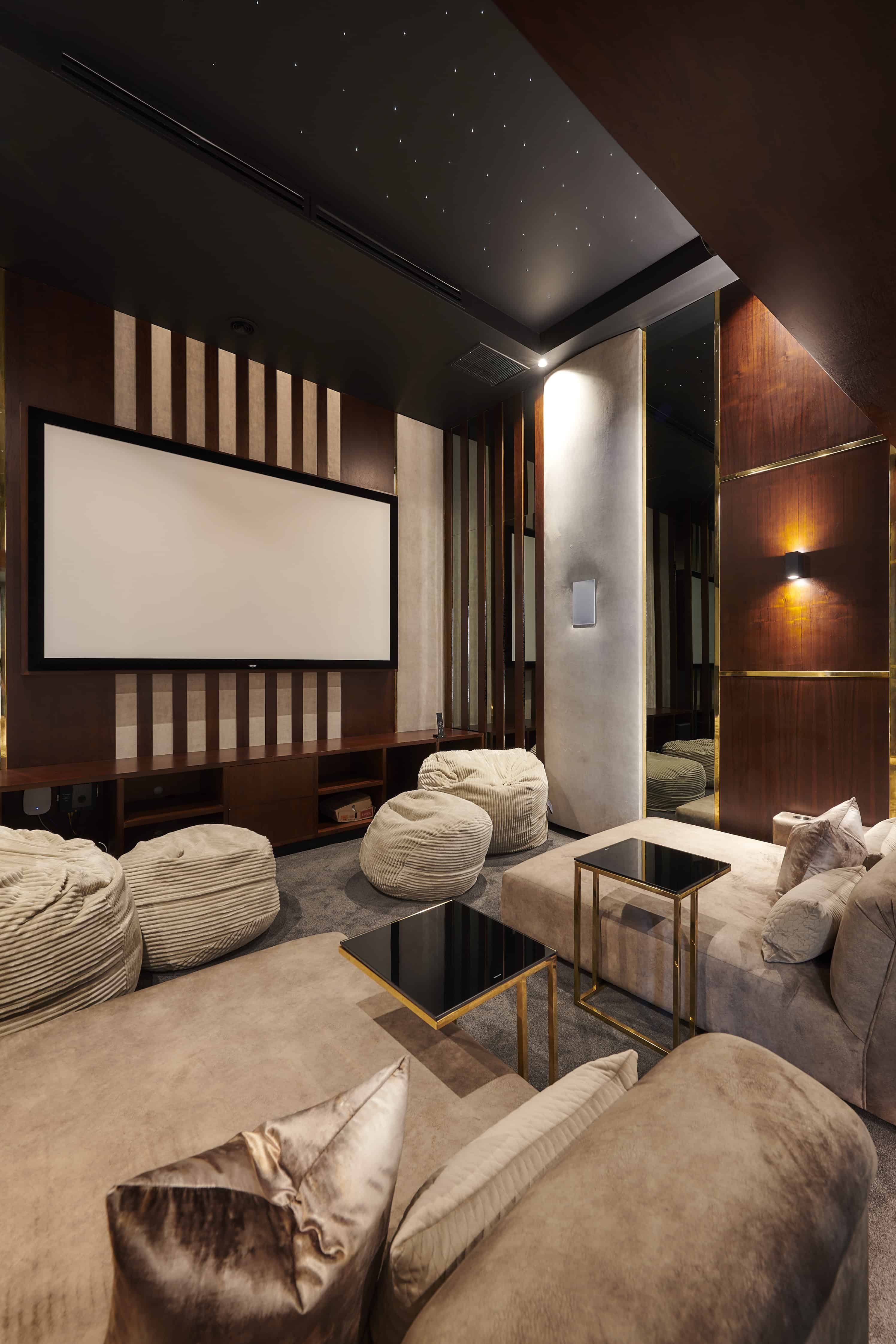 Luxury home theatre with ambient lighting and plush recliner seating by Interior Designer Johannesburg.