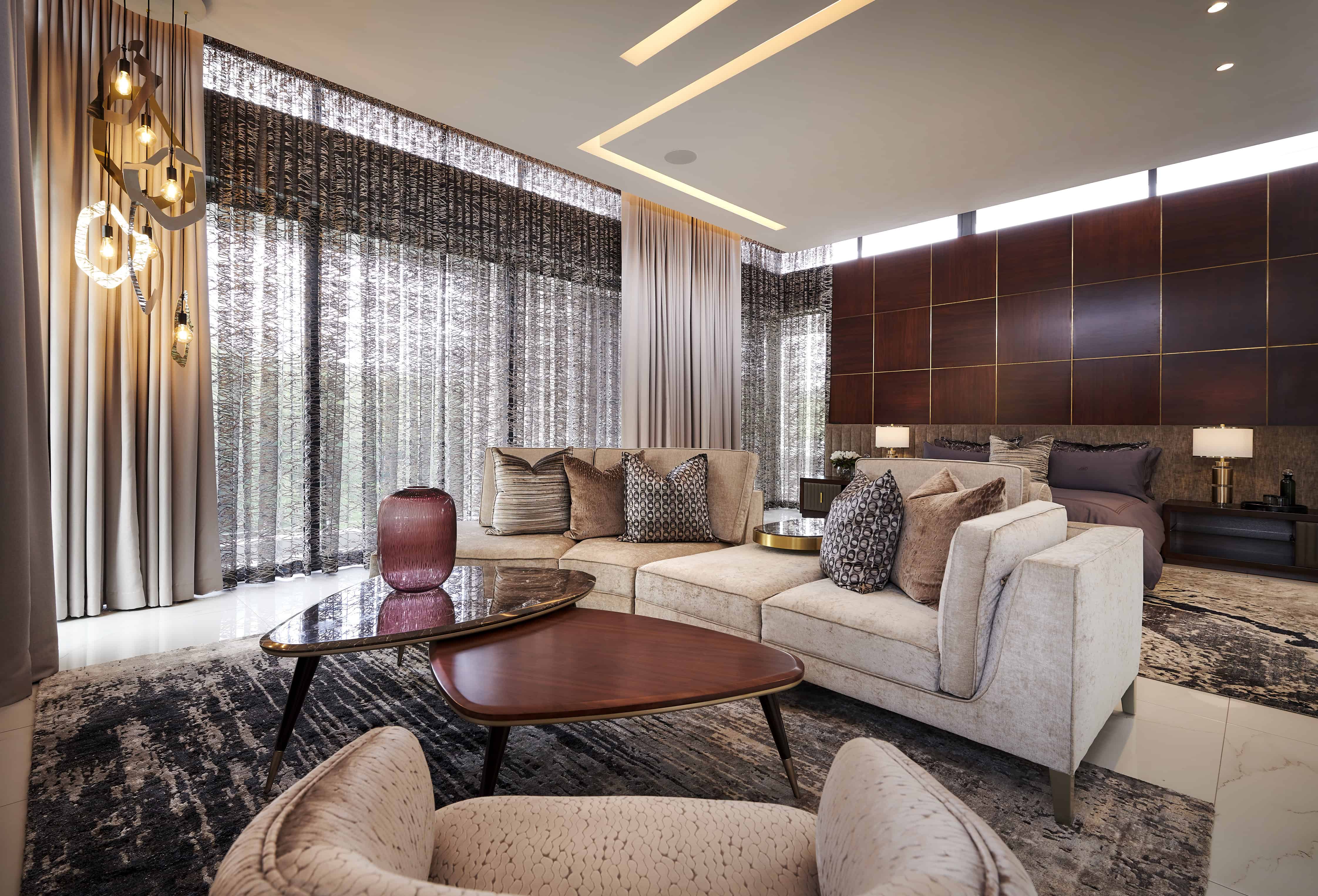 Stylish living room with plush sofas, coffee table and floor‑to‑ceiling curtains crafted by Interior Designer Johannesburg.